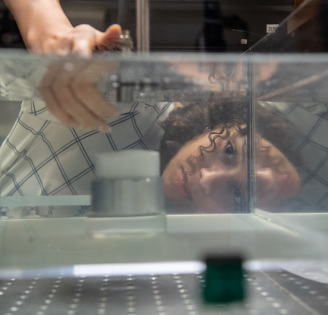 A student works on a project in a lab on campus