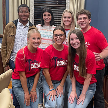 A small team of Ole Miss Social Media Ambassadors pose for a photo after an event