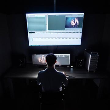 Student sits at computer screen