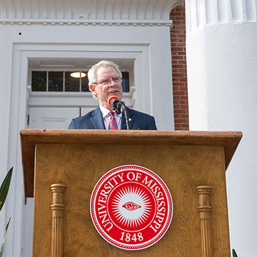Chancellor Glenn Boyce address a crowd from a podium in front of the Lyceum