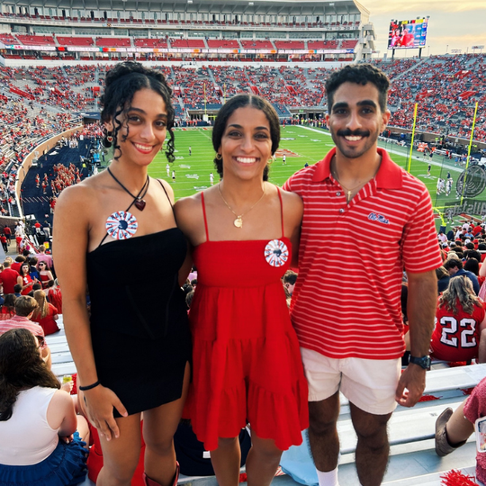 An image of Sarah, Elizabeth and Michael Basha at a home Ole Miss football game.