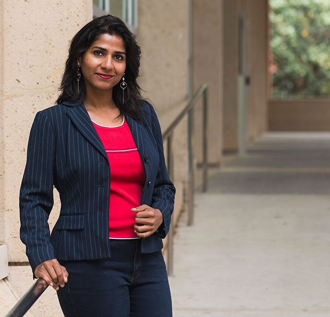 Stefali Pawar, a driven journalism and new media student at the University of Mississippi, captures the essence of storytelling against a backdrop of bustling newsroom activity, embodying her passion for diverse perspectives and impactful narratives.