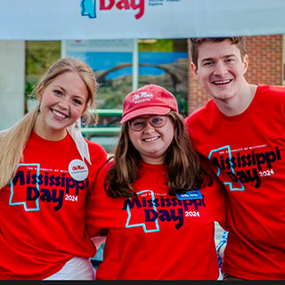 Macey Ross, alongside two friends, represent their department during the Mississippi Day event