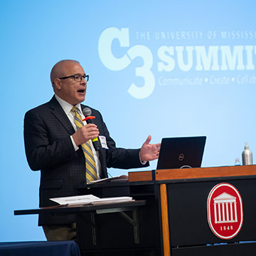Provost Noel Wilkin addresses the crowd from a podium during the 2019 UMC3 Summit