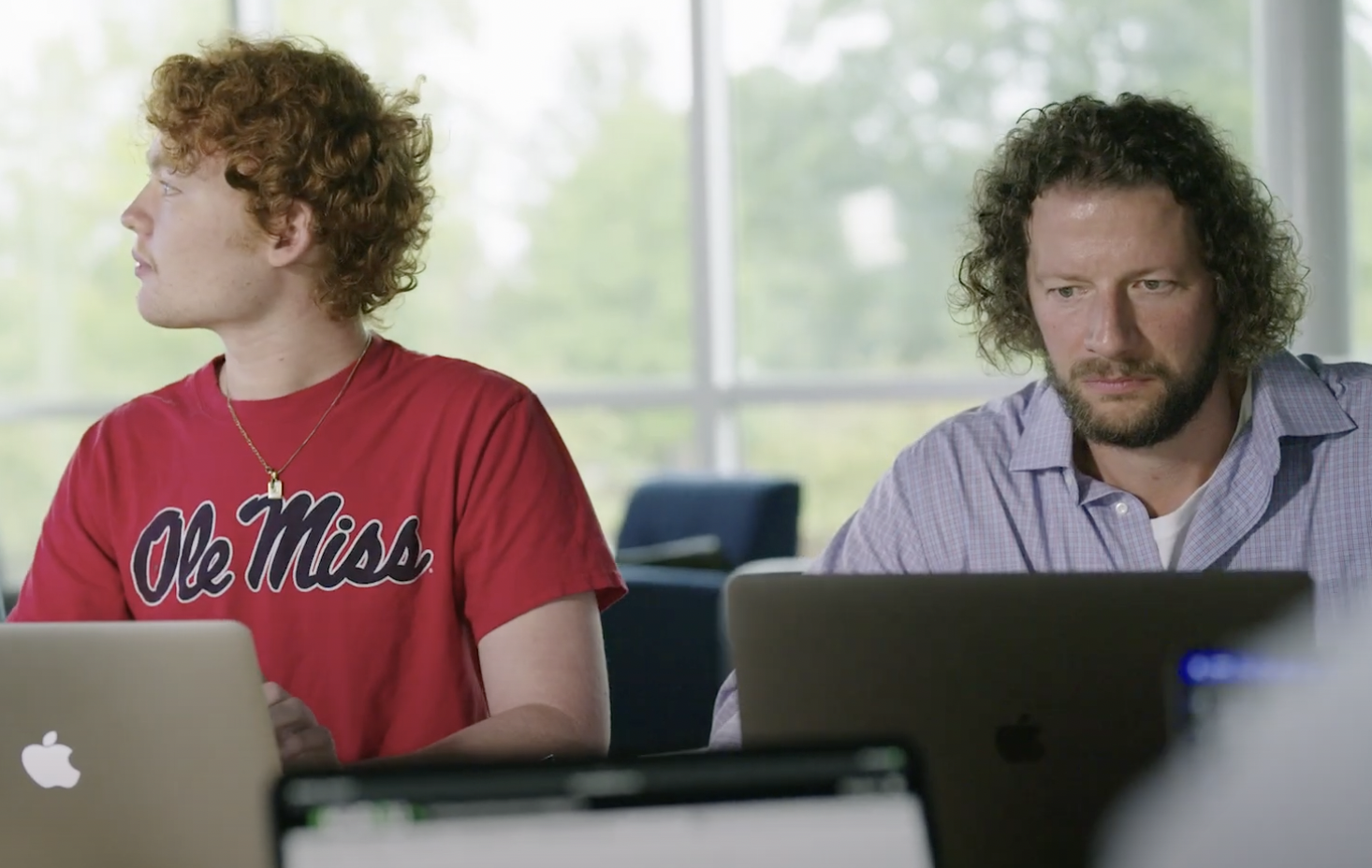 An Ole Miss student and faculty member in a classroom