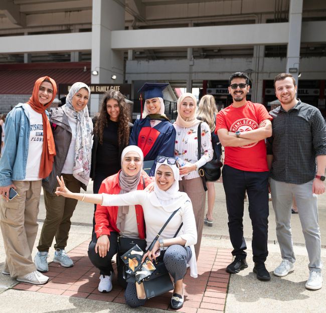 A family celebrates graduation outside the Vaught.