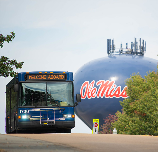 An OUT bus drives through the Ole Miss campus.