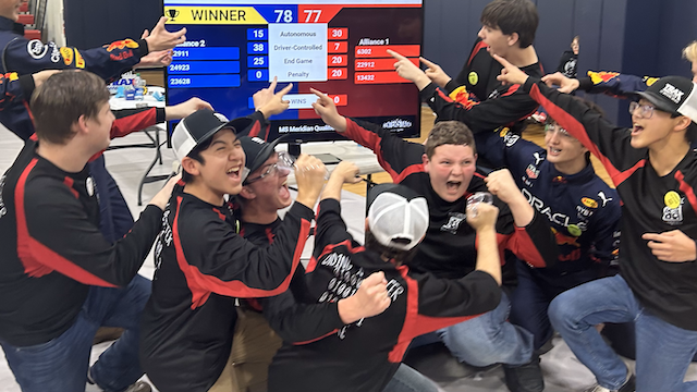 students celebrating winning their robotics challenge