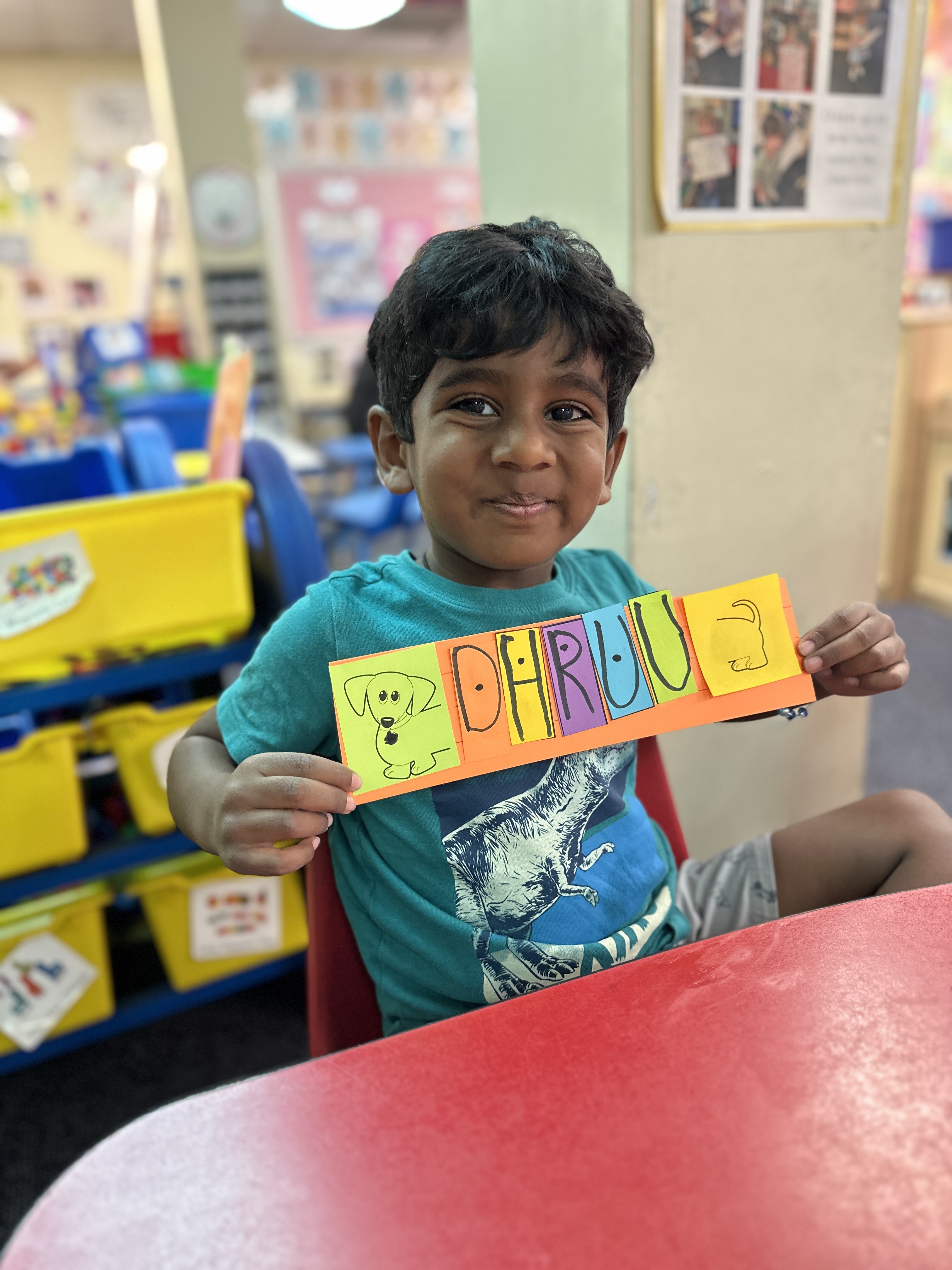 A student proudly shows off the name card he crafted.