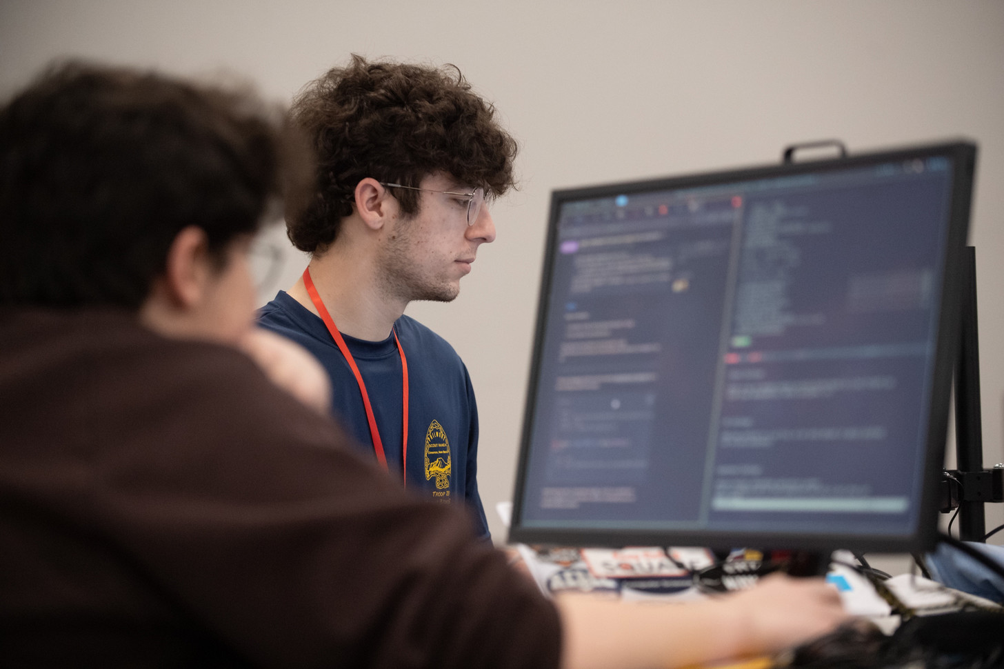 Two computer science students focused on a coding project.