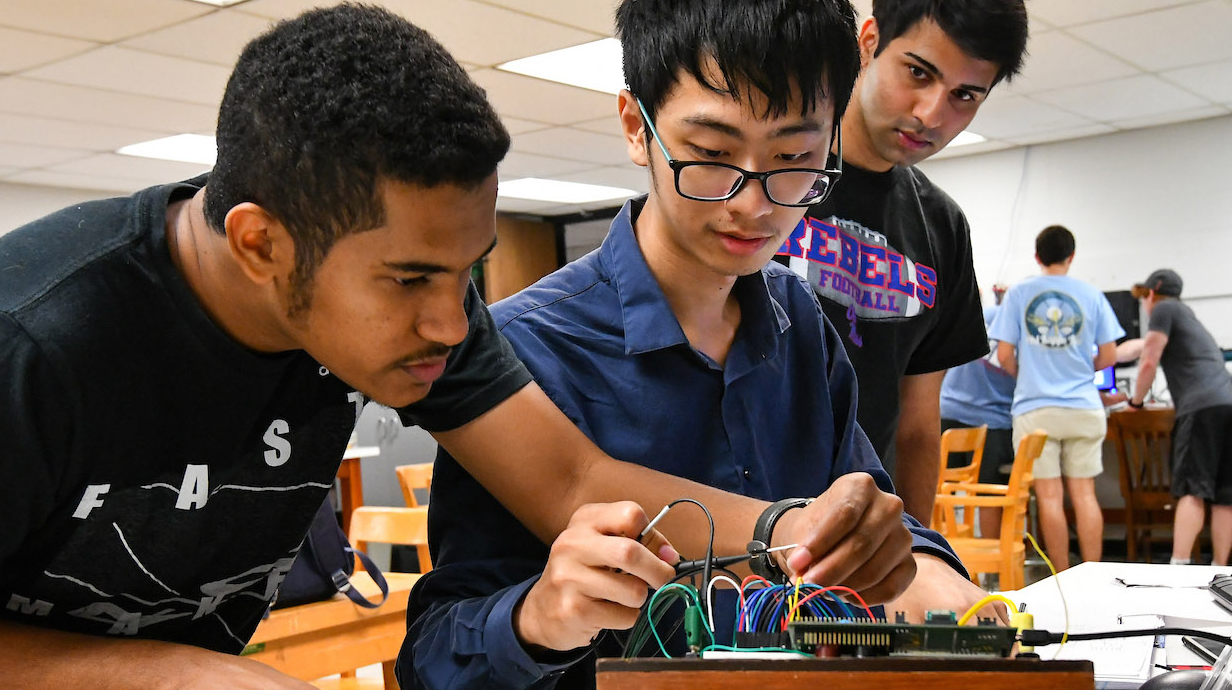 A group of students work on an electronics project