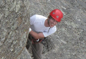 Charlie King standing atop a rock formation