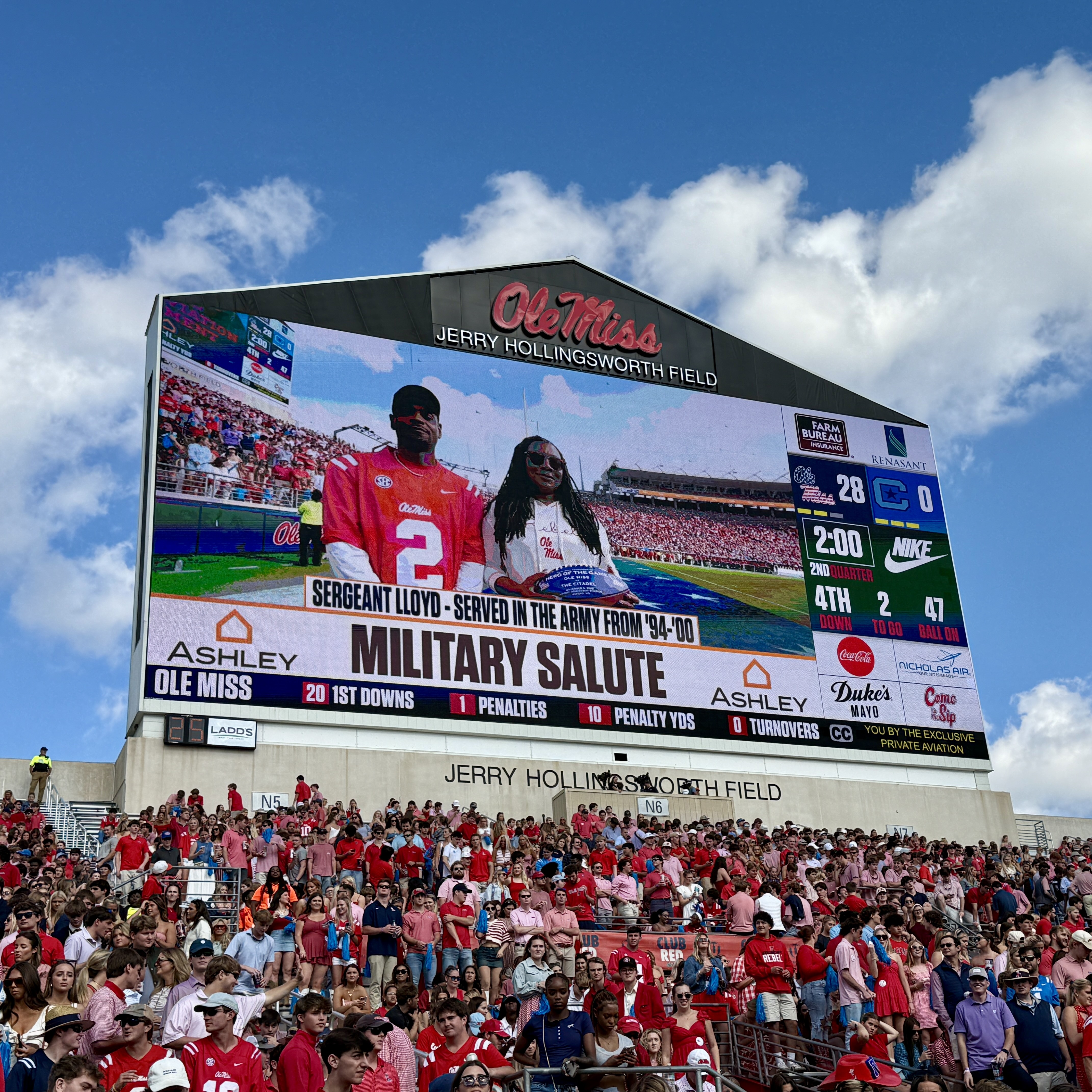 Sergeant Lloyd depicted on UM scoreboard in recognition of service.
