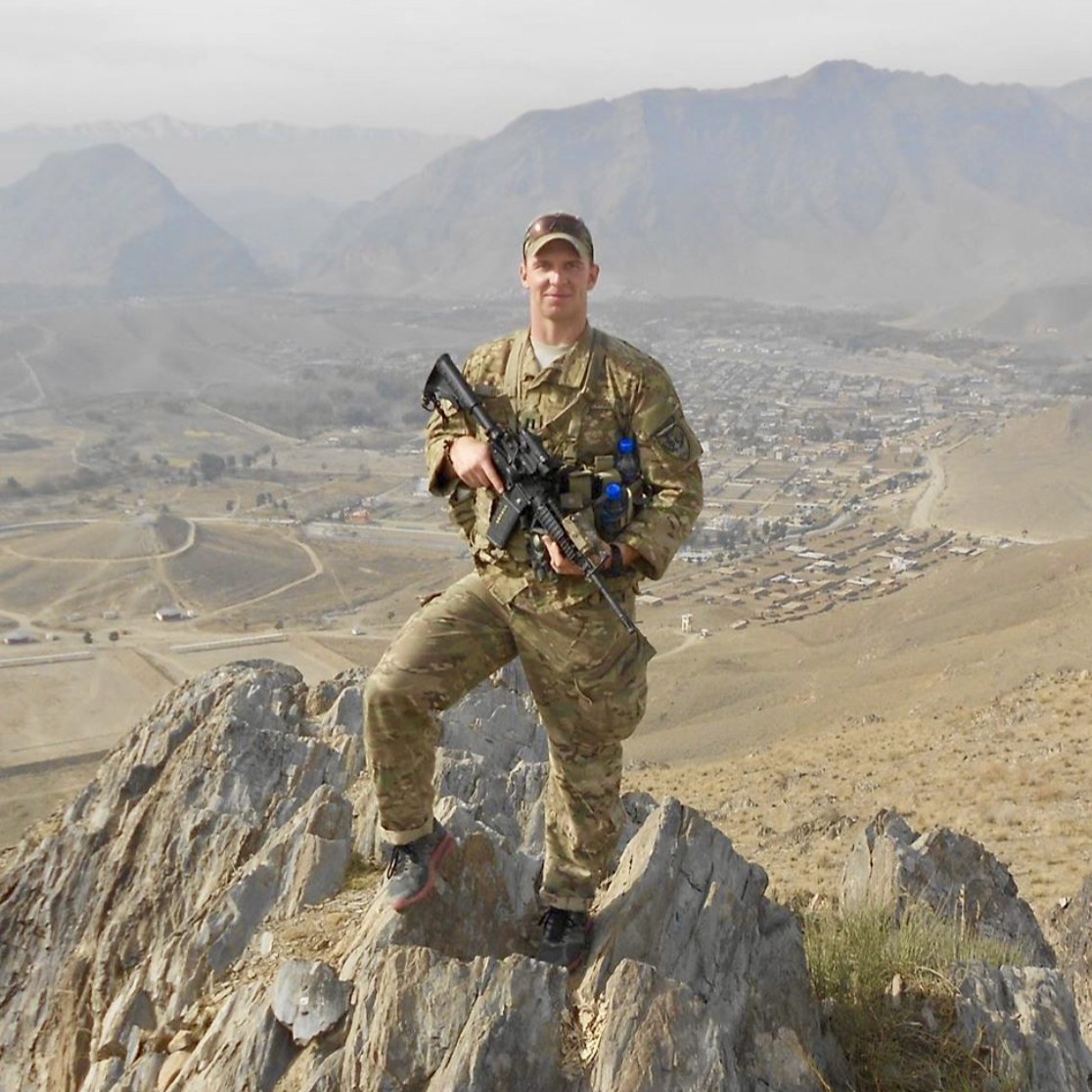 Service Member Stands on Mountain Range