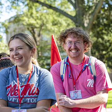 Two students smile and laugh in the Circle during an Orientation session