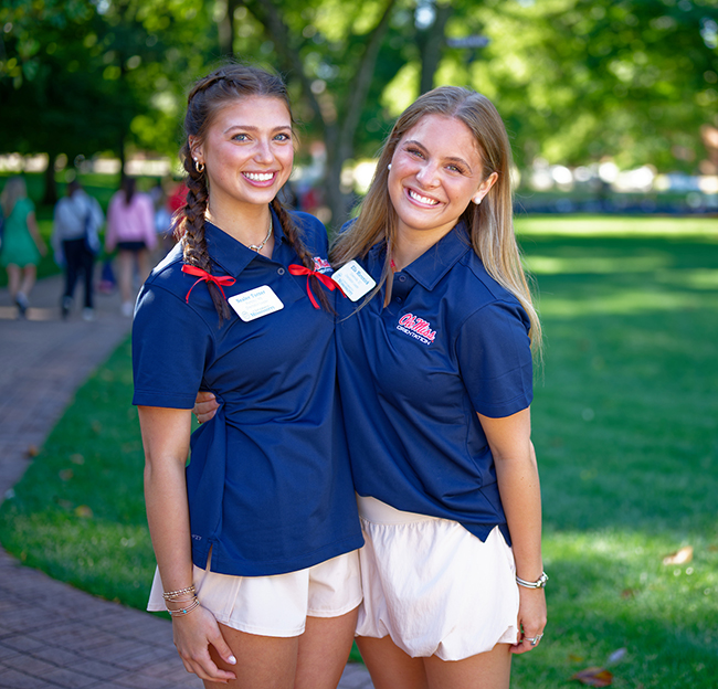 Freshman students sit in a circle in front of the lyceum during orientation