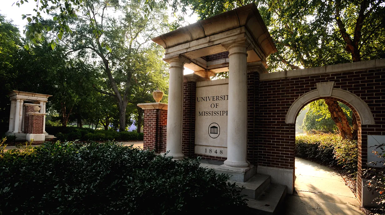 An entrance to campus on University Avenue is shown during an afternoon sunset.