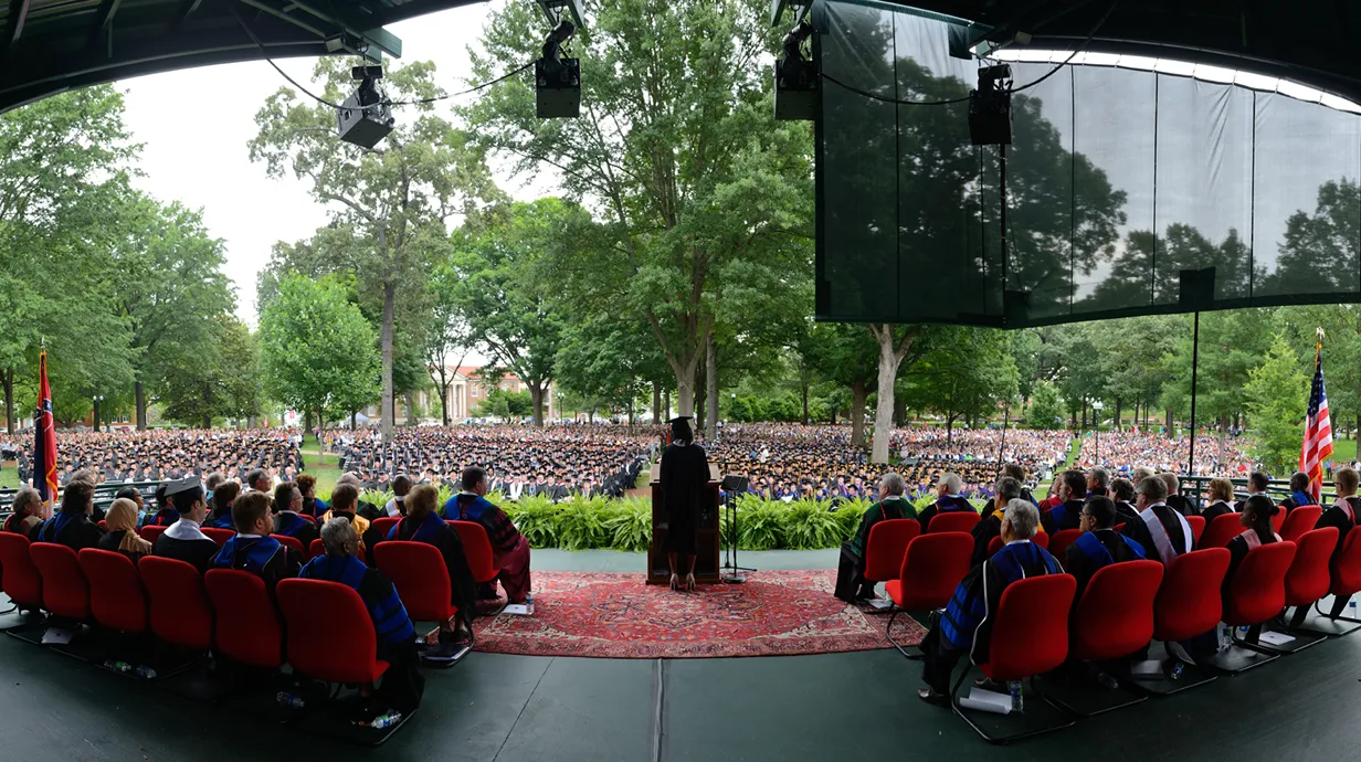 The Chancellor speaks during a graduation ceremony in the Grove.