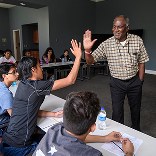 a teacher and student high-five
