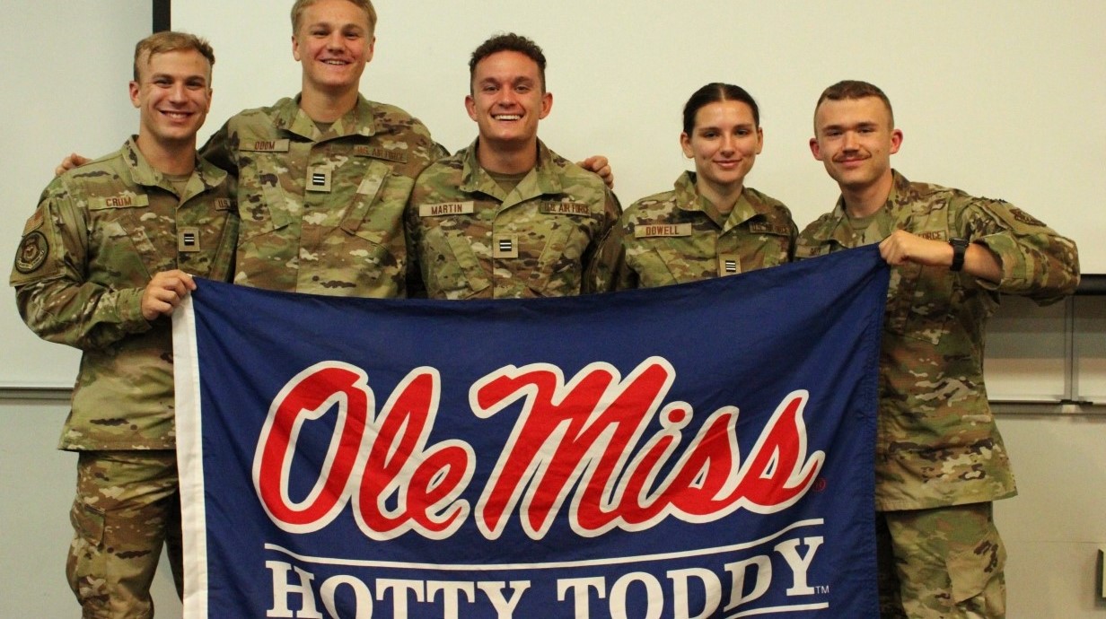 image of a group of students holding a banner with Ole Miss Hotty Toddy