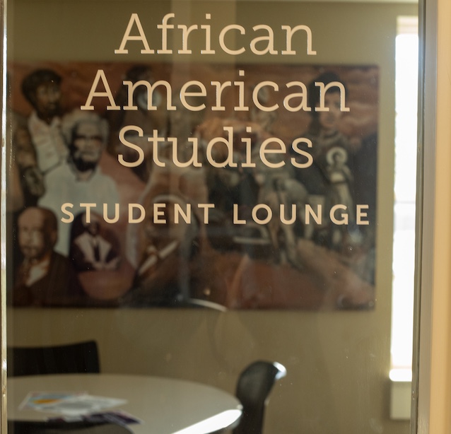 Glass door with sign that says "African American Studies Lounge"