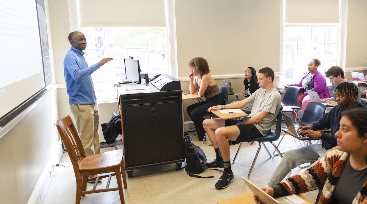 professor stands in front of classroom