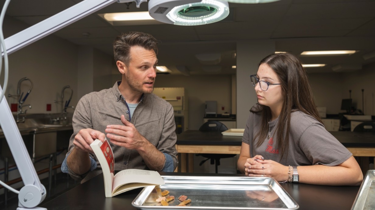 image of student and professor working in a lab together
