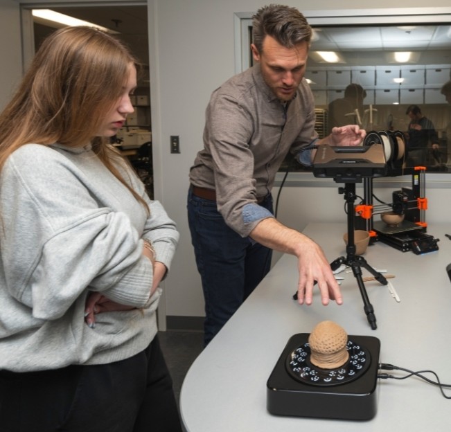 image of a faculty member and student in a digital lab for archaeology