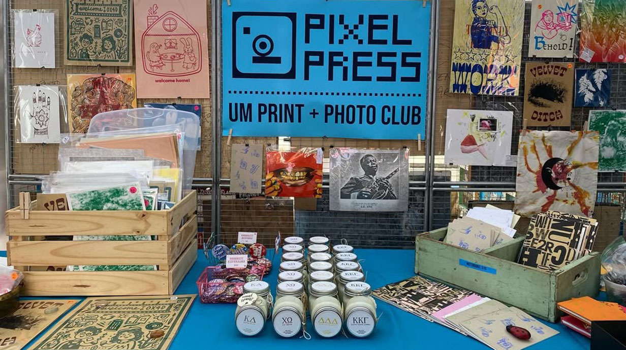 Table with items created from "Pixel Press, UM Print + Photo Club"