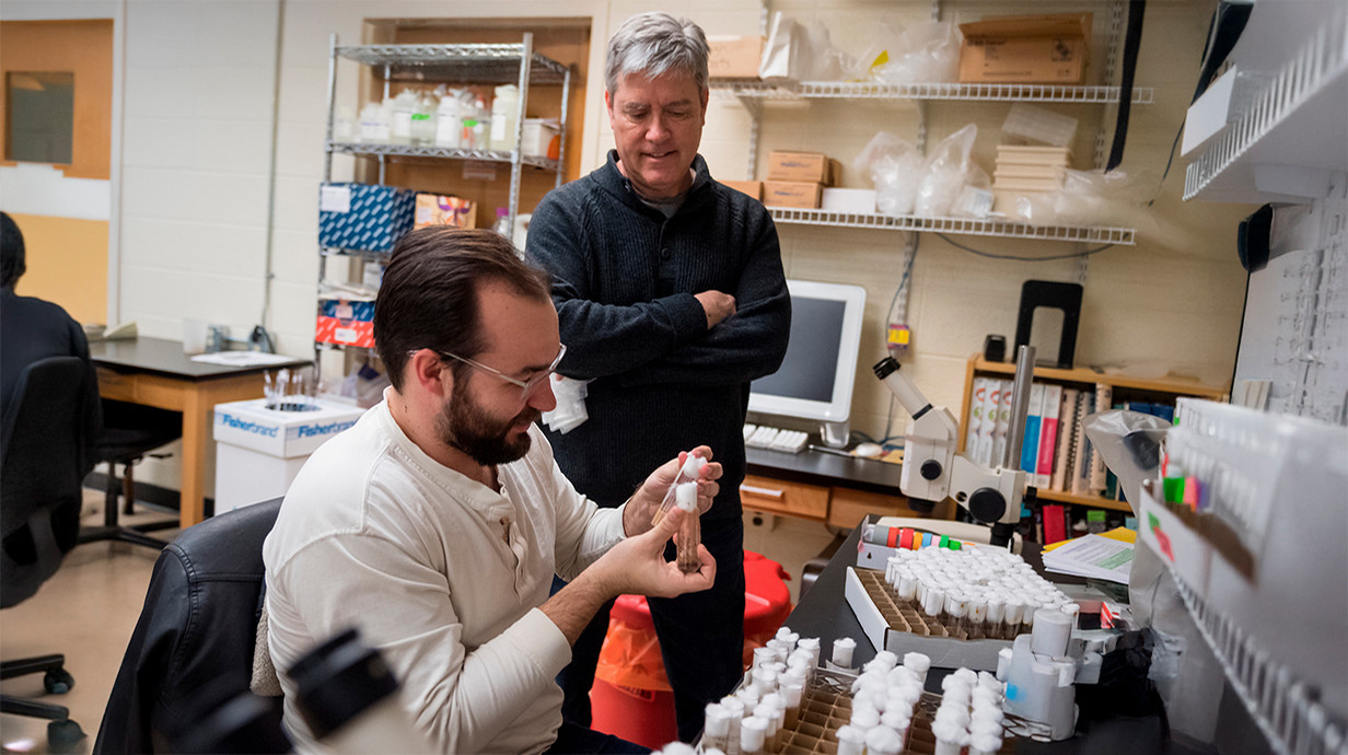 professor working with student in a lab