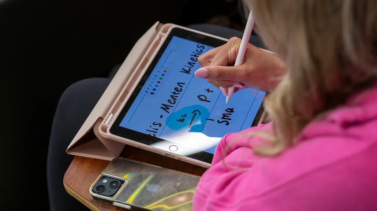 person writing on a tablet
