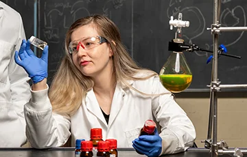Eden Tanner holding vial around other lab equipment