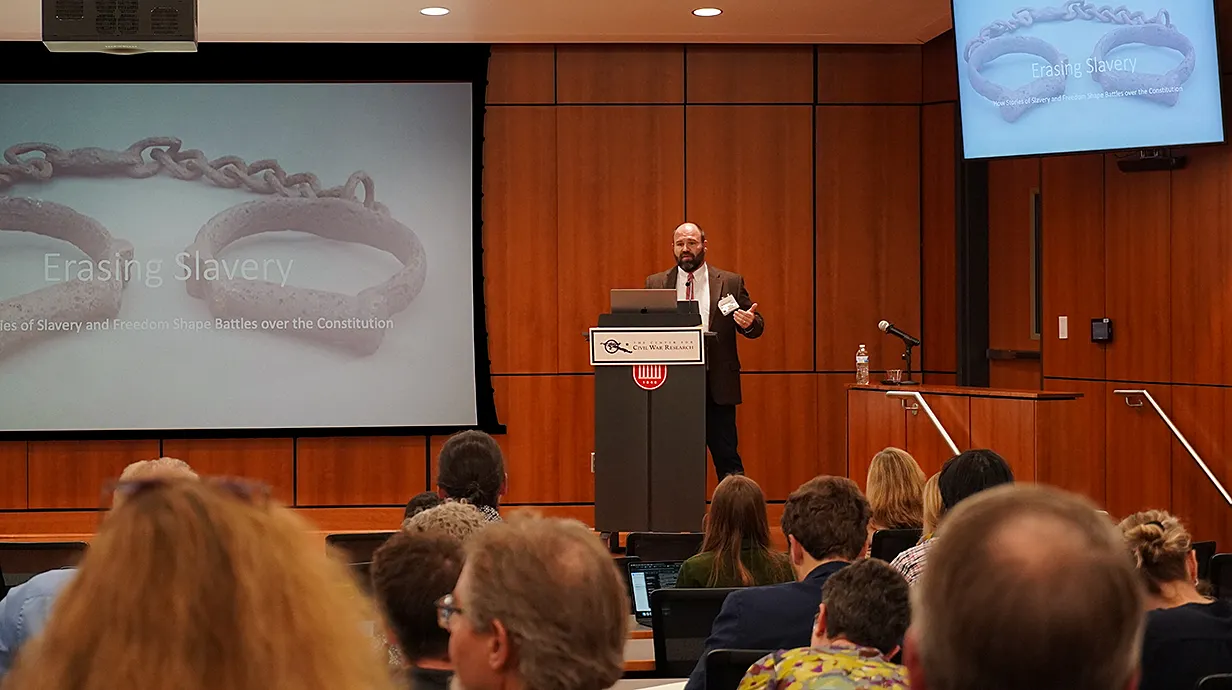 Robert Colby speaking at conference keynote