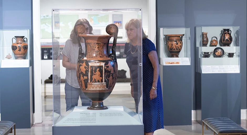 Student and professor in museum looking at Italian pot