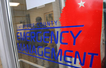 blue emergency management with red Mississippi logo on glass door