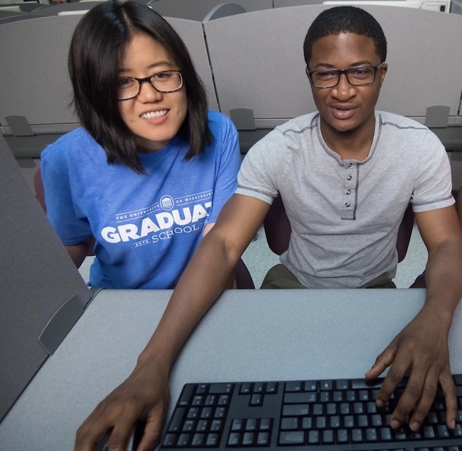 two graduate students at work