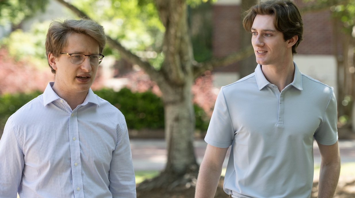 student and professor talk outside