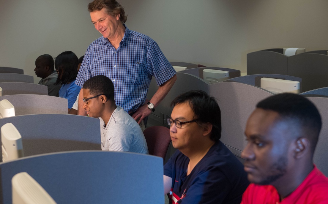 professor instructs students in computer lab