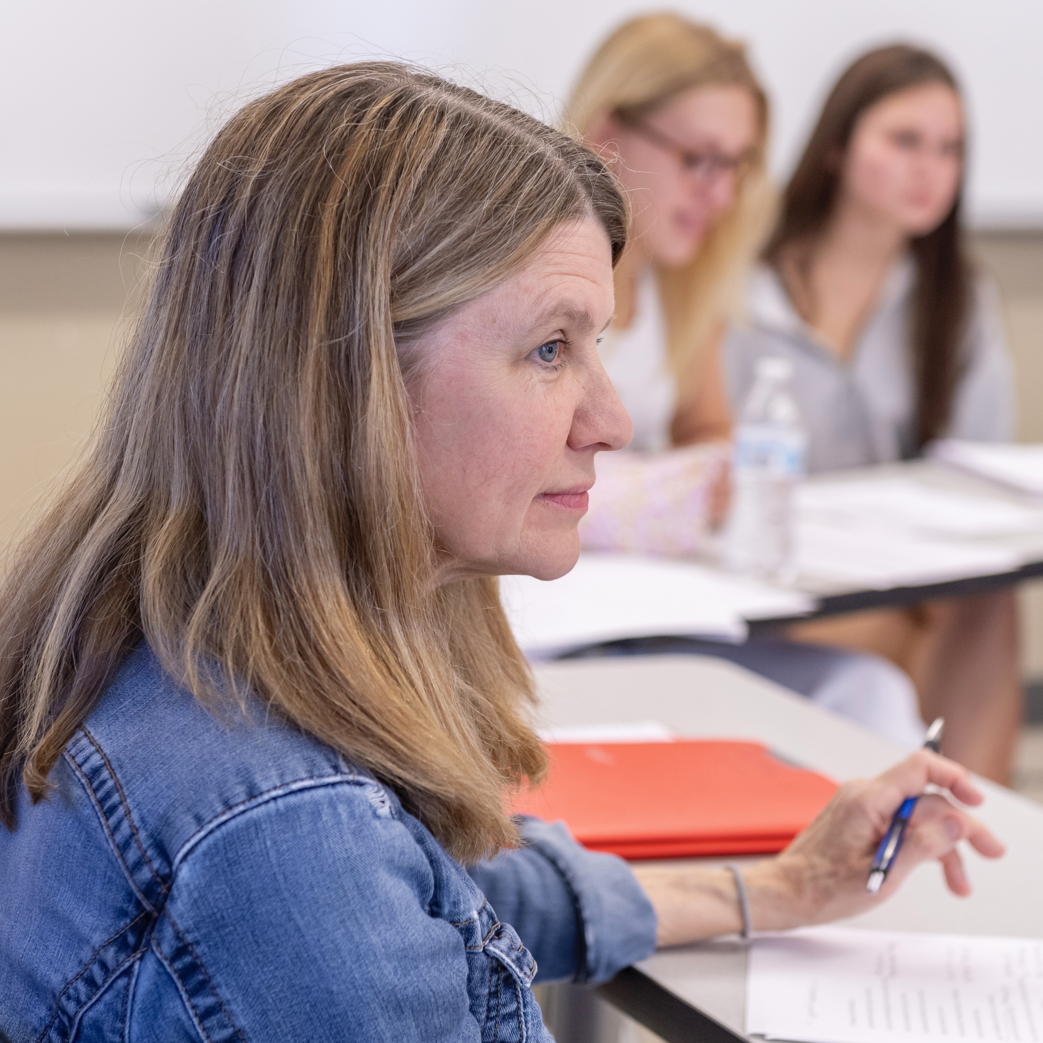 Faculty member Beth Spencer listens to students during round-table class time