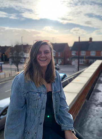 girl sitting and smiling outside