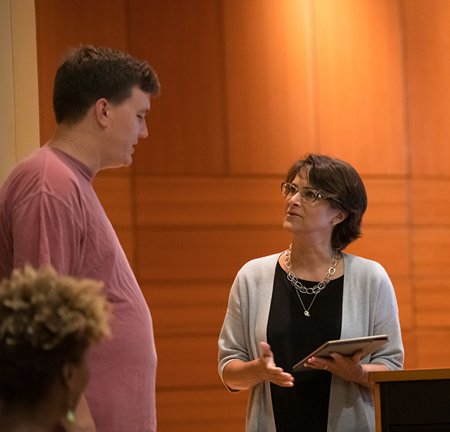 Student and guest lecturer talking