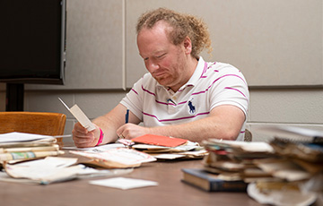 male student looking through old documents