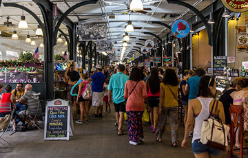 people walking in a busy food market.