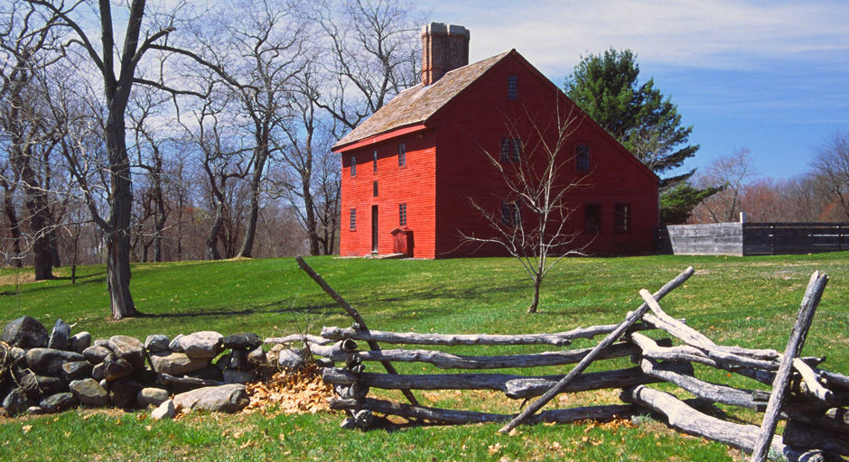 Red building in a field of green grass