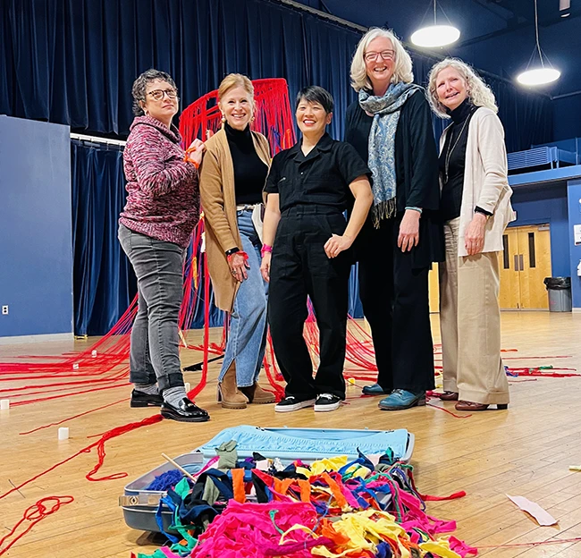 Sarahfest organizers pose with resident artist and their works