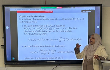 female grad student giving a presentation