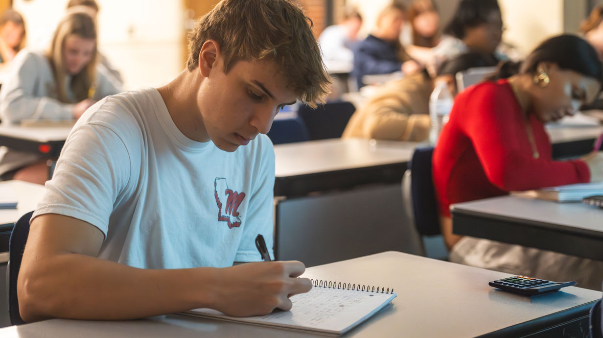 student taking math notes