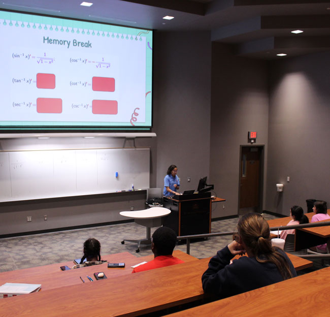 student tutoring in big classroom