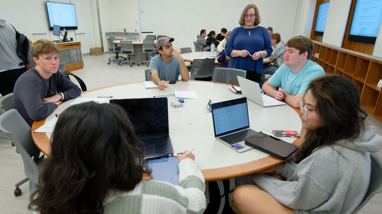 students sitting around a round table discussing