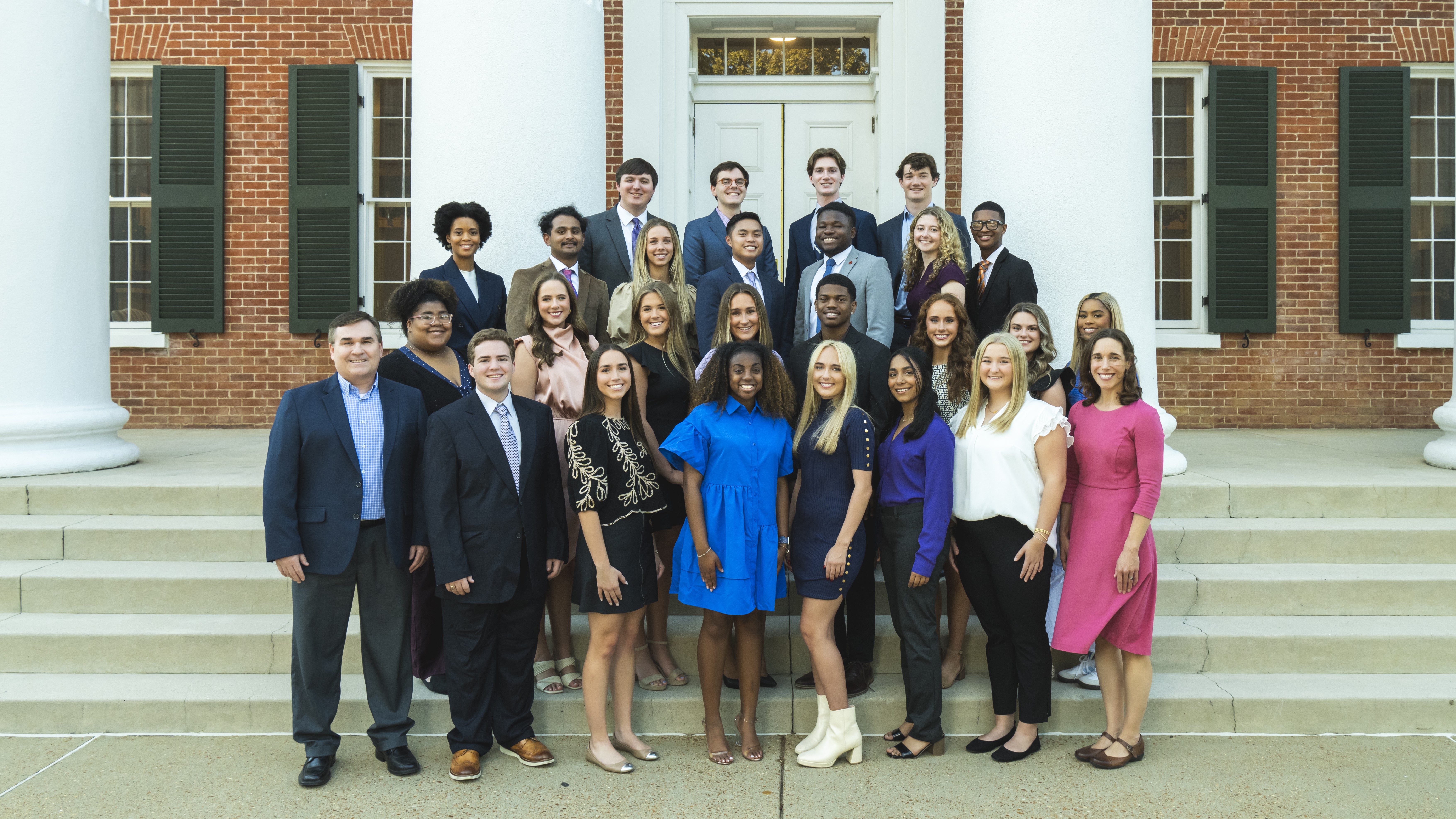 2024-2025 cohort of the CEED Initiative stand in front of the Lyceum with Grisham-McLean staff members.